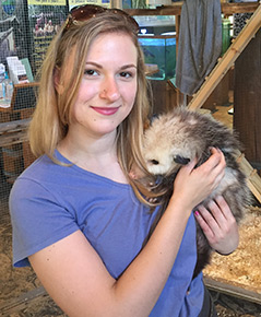 Sarah holding an opossum