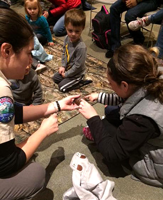 Naturalist showing small turtle to children