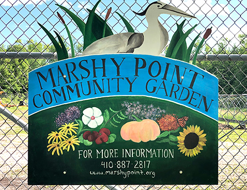 Community garden sign on fence